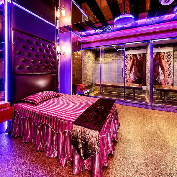 Purple-red bedroom suite with strong stage lighting for guests who prefer a more dramatic mood photo