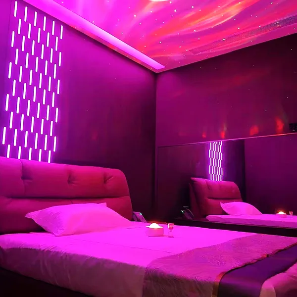 Purple-lit bedroom suite with a softer atmosphere for a modern private-room feel photo